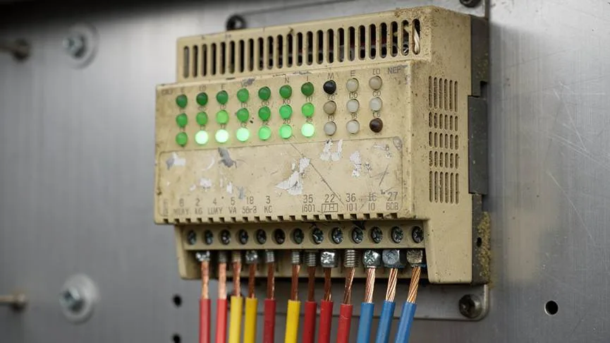Weathered industrial PLC controller with connected cables